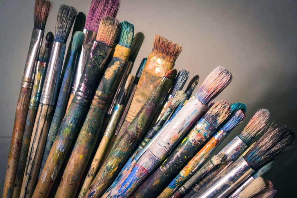up-close assortment of used artist’s paintbrushes